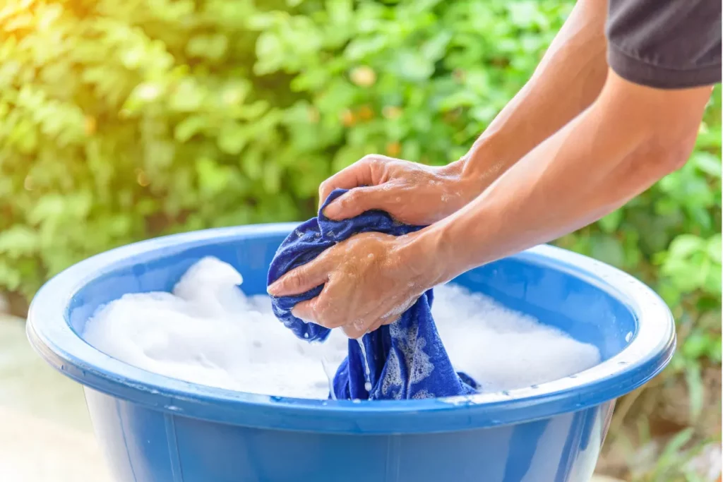 Washing clothes with detergent in a basin