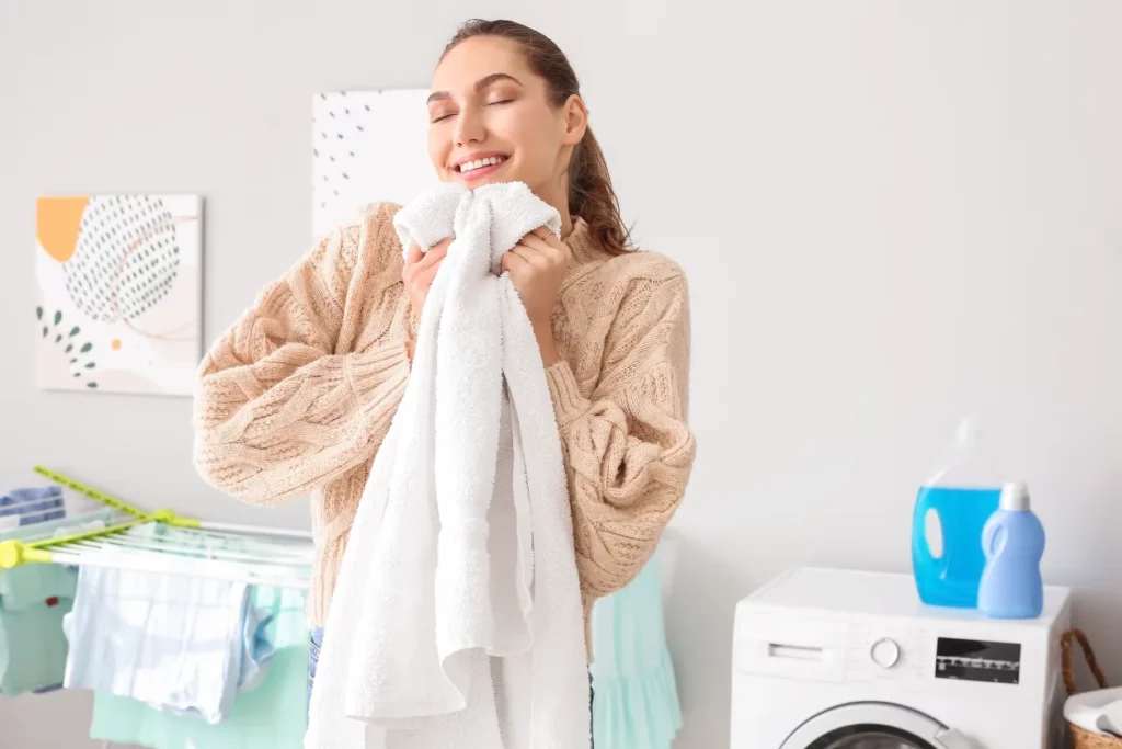 Happy woman holding a conditioned clean towel