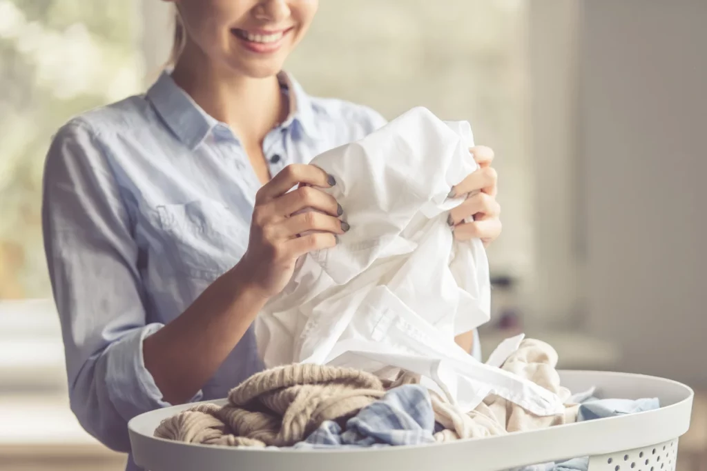 A woman looking at dry clean clothes