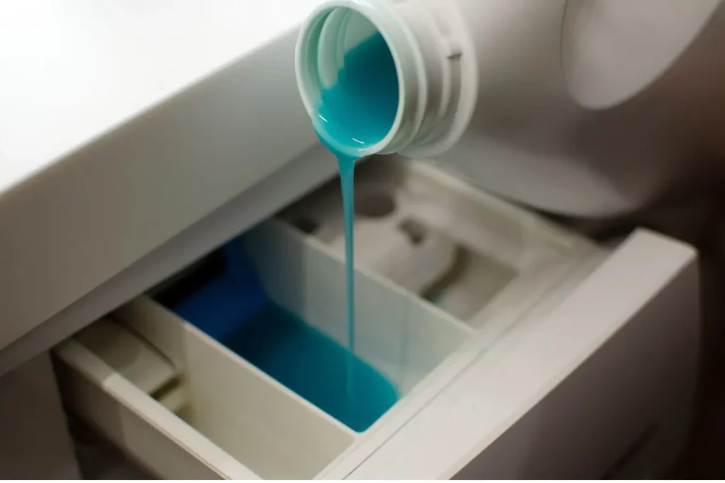 Pouring detergent into a washer